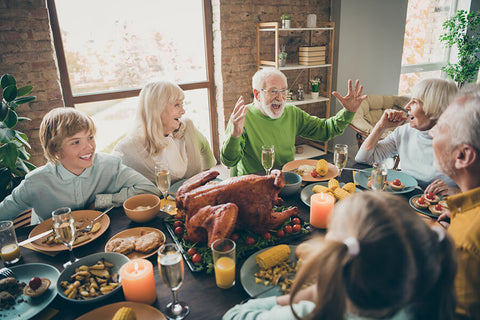 A family happily shares conversations while enjoying a fruitful feast