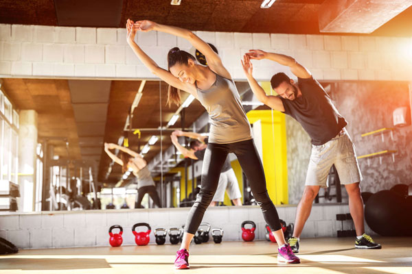 Man and woman doing warm-up stretching