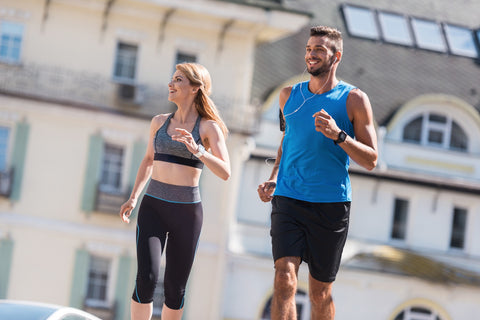 An athletic couple wearing sportswear is doing exercise together