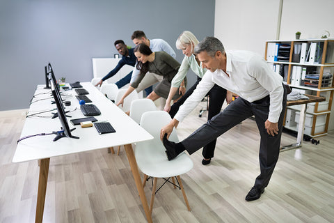 A group of office people taking a time out from work to do some exercise routine