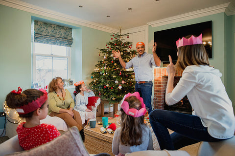 A family is having a great time celebrating Christmas in their living room