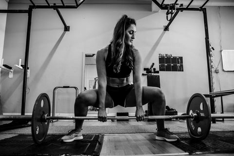 a girl deadlifting
