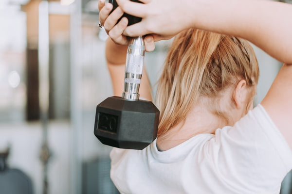 a woman lifting dumbbell