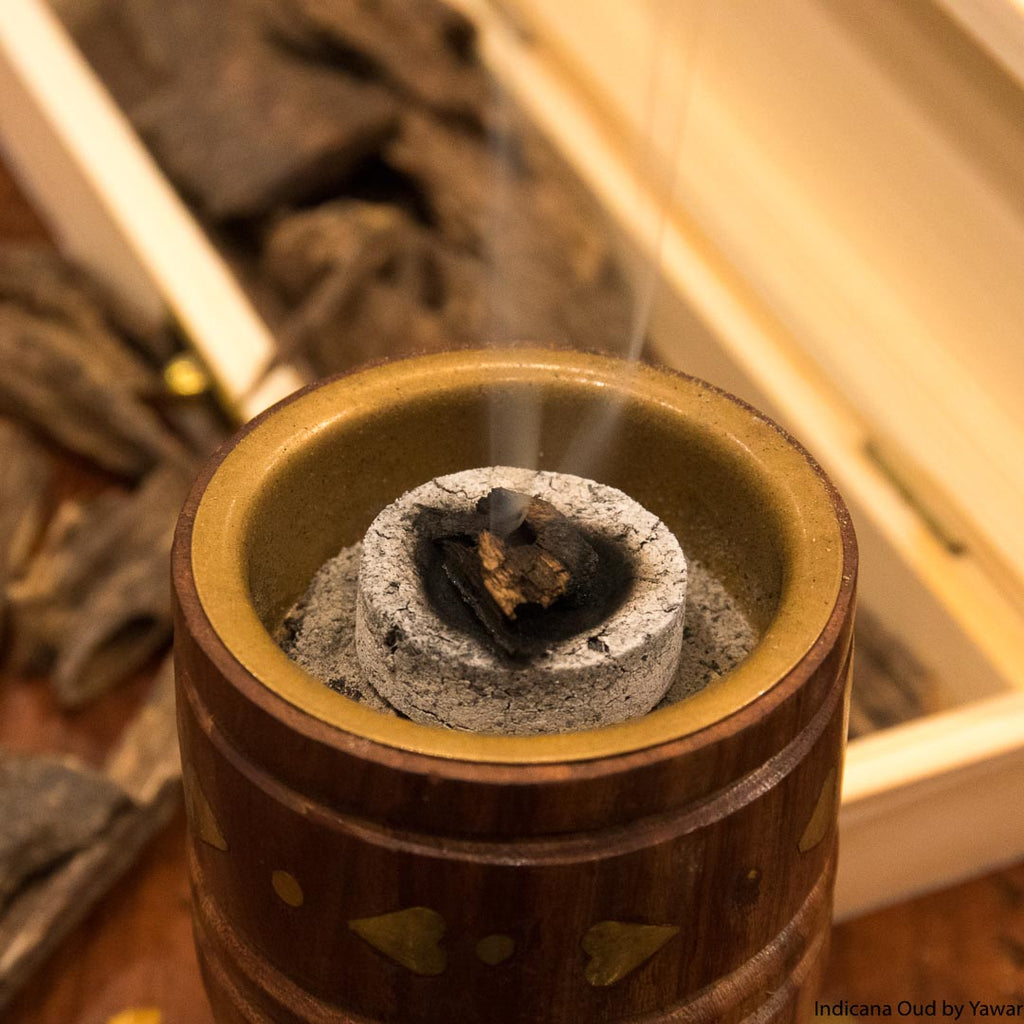 Oud burnt on top of charcoal for perfuming