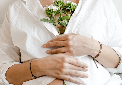 pregnant woman holding flowers