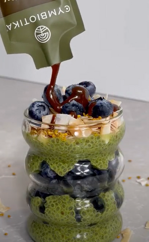 Pouring Longevity Mushroom on Matcha Chia Seed Pudding