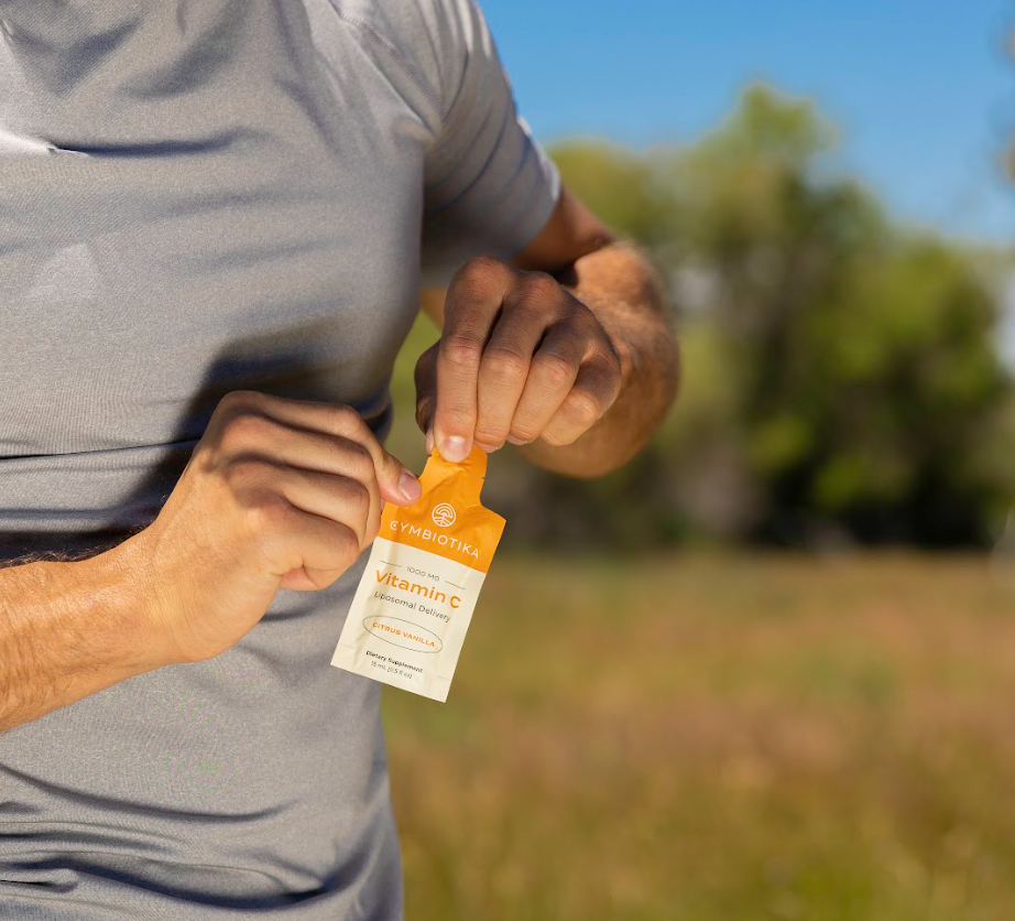 Man opening a pouch of Cymbiotika Vitamin C