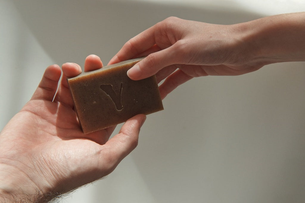 Handing over a bar of soap