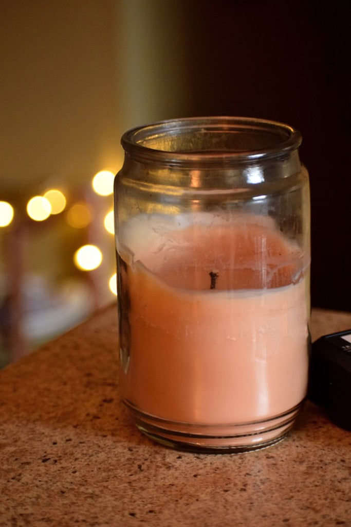 A candle in a glass jar