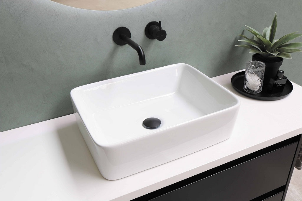 White washing basin a black tap