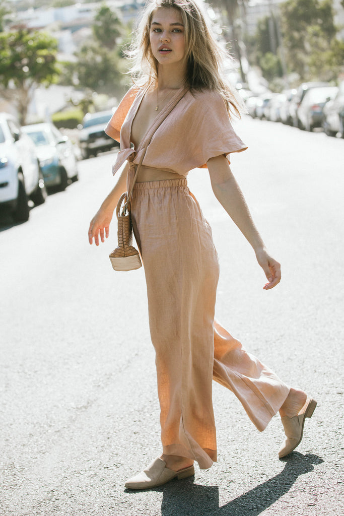 our model wearing brown coordinates and a bag in the middle of the street