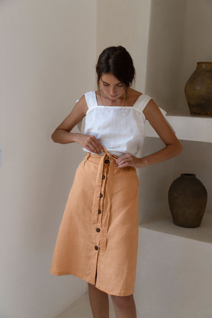 Women with dark hair wearing Hazel and Folk Gretta Skirt which is made with recycled coconut buttons