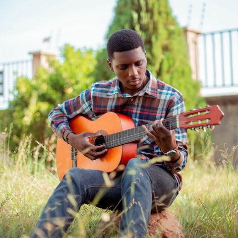 Boy Playing Guitar In Nature