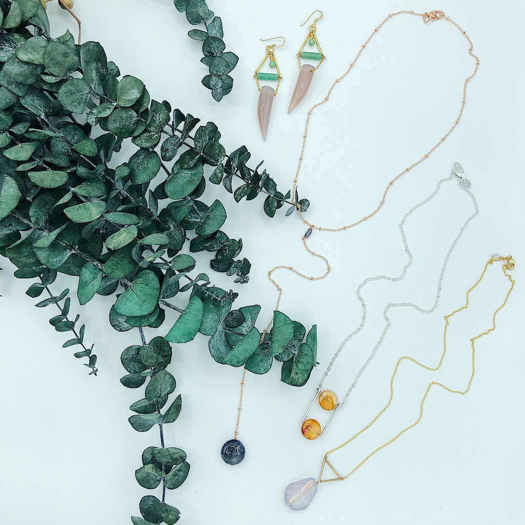 Third and Co Studio handmade semiprecious stone jewelry; Andromeda Necklace with gold plated satellite chain and blue Iolite lariat, Ursa Necklace in sterling silver and red orange carnelian, Prism Necklace with rainbow electroplated faceted quartz and vermeil chain with eucalyptus 