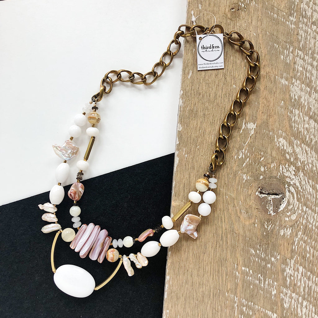 Semiprecious stone statement necklace from Third & Co. Studio handmade in Michigan with white Jade, peach Fresh Water Pearl, pink Baroque Pearl, pink Mother of Pearl, brass accents and vintage brass chunky chain with toggle closure