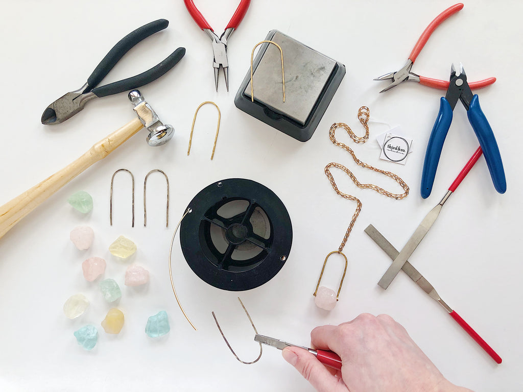 Product design and development with Third & Co. Studio, handmade semiprecious stone necklaces in Michigan; using pliers, hammers, wire cutters, metal files, brass and rough cut Quartz