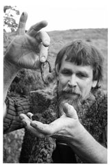 Author Herwig Pommeresche holds up an earthworm
