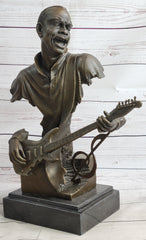 bronze sculpture of a black guitarist