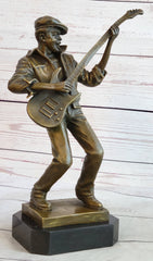 bronze sculpture of a musician playing bass guitar