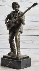bronze sculpture of Rick James playing guitar