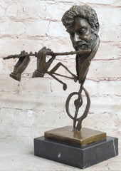 abstract bronze sculpture of a man playing the flute