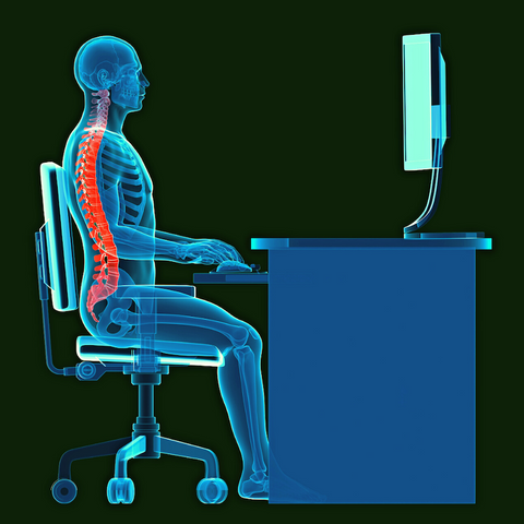 A graphic of a skeletal structure sitting correctly at a desk