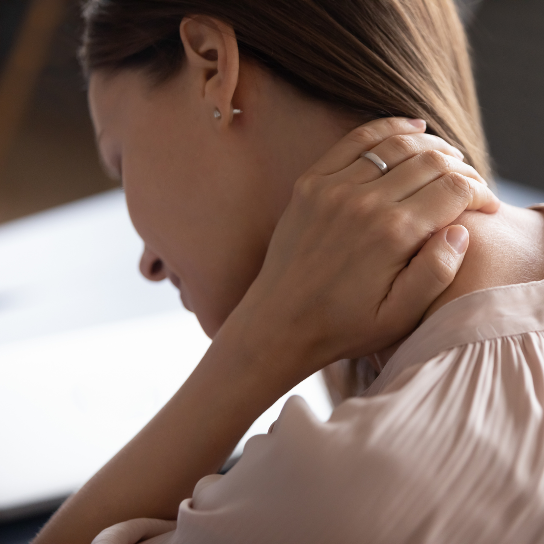 a woman holding her neck in pain
