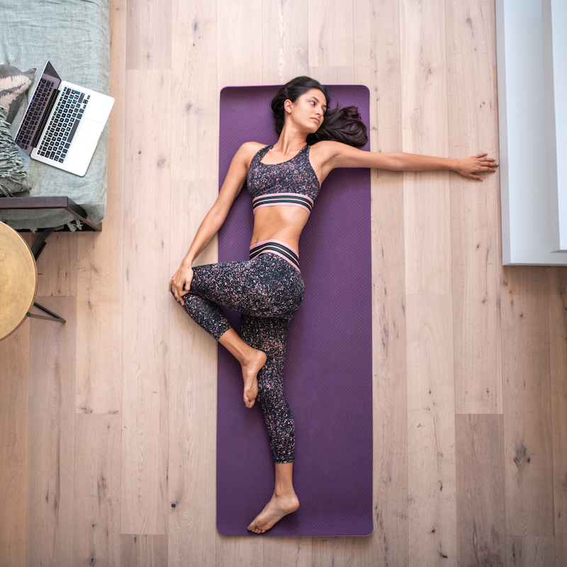 Woman stretching on her floor at home