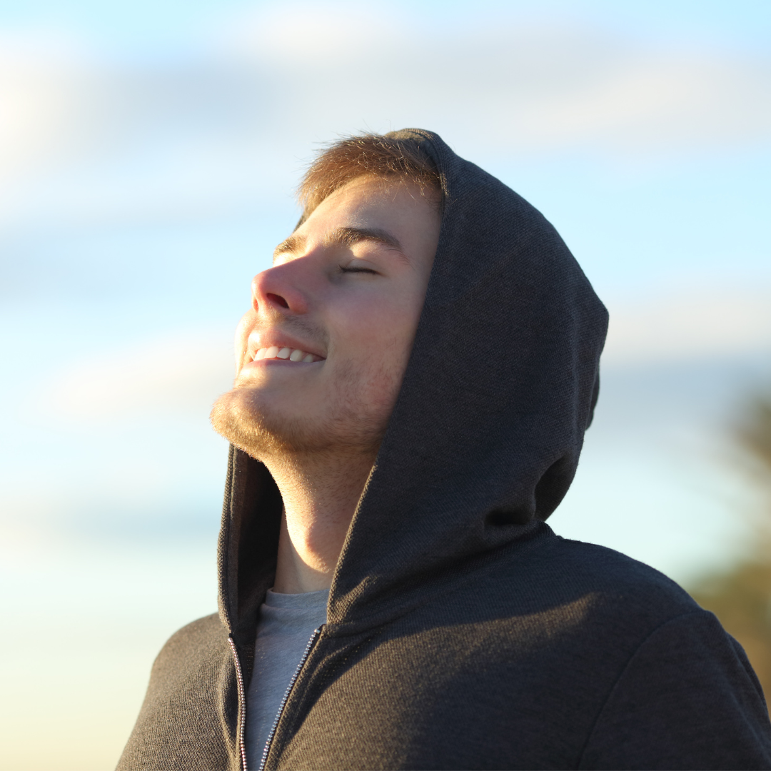 a man breathing deeply and smiling