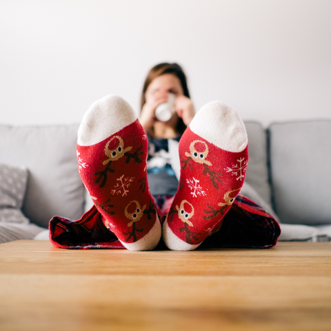 A woman relaxing at home with cozy socks