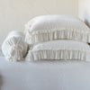 Loulah Sham - Renewal | Winter White | Two shams stacked flat next to matching bolster. Close-up side view highlights the ruffle trim.