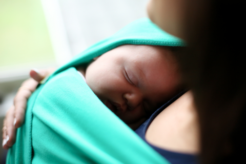 baby sleeping in an emerald boba baby wrap carrier