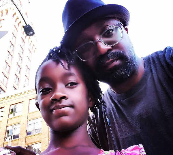 african american father and daughter malaya and jason austin taking a picture in done town oakland