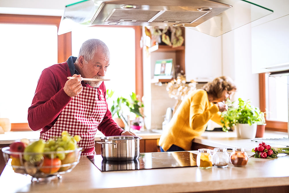 Couple in kitchen cooking.