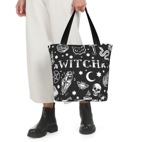 model holding a tote bag that has witchy designs on it