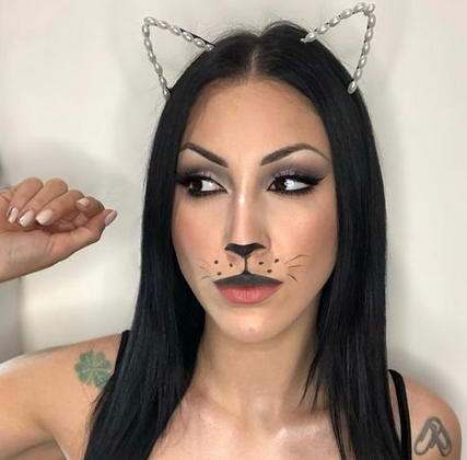 model wearing cat ears headband and cat nose and whiskers makeup