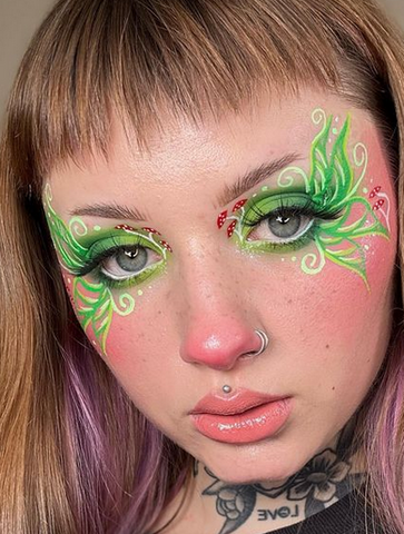 model with green fairy wing eyeliner and mushrooms