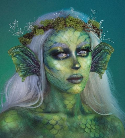 model wearing an elaborate green mermaid makeup look