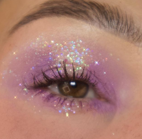 model wearing a diffused lilac eye look with glitter over top