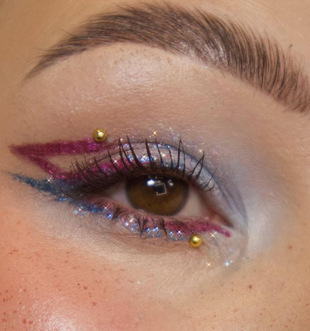 model wearing glitter under the eye across the lash line