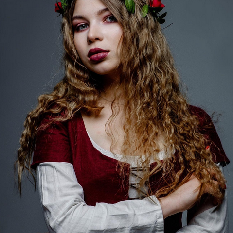 model wearing renaissance themed makeup and red dress