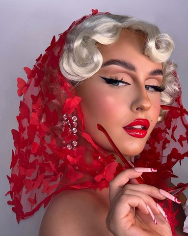 Model wearing Marilyn Monroe Classic siren eye makeup and red lipstick, with a red lacy head scarf