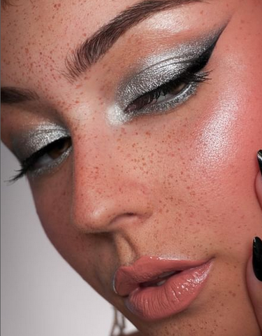 model wearing a metallic silver eyeshadow and winged liner