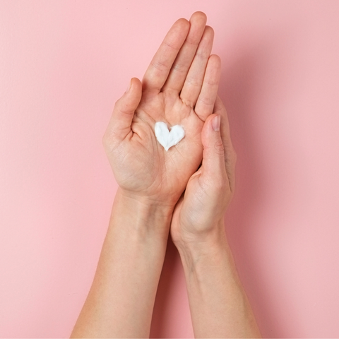 lotion in hand shaped like a heart