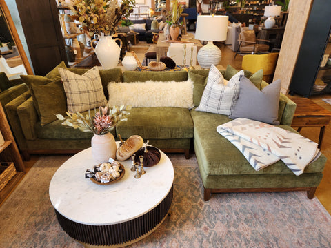 green velvet sofa with marble top table