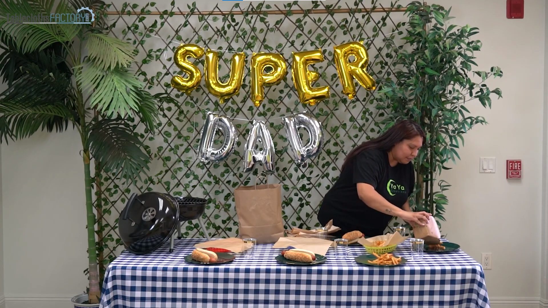 Woman adding hotdog sandwiches and fries on the dinner plates