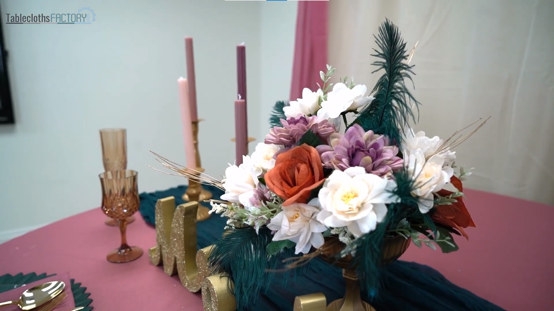 Artificial flowers, candles, and candle holders arranged on the table