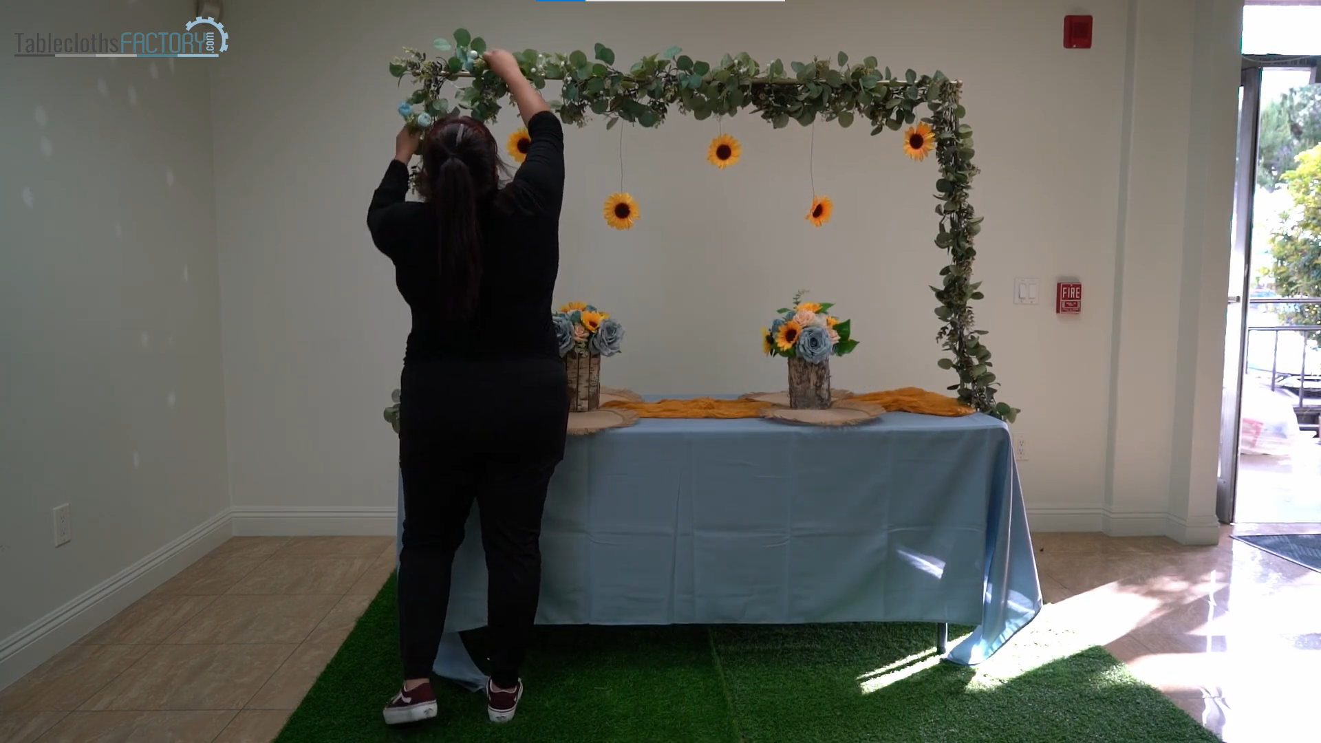Person setting up the floral decor