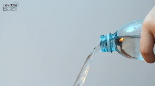 Pouring water from a bottle, illustrating the importance of not overfilling the steamer.