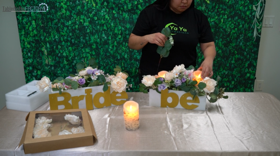 Woman arranging floral decors and LED pillar candle inside the planter box